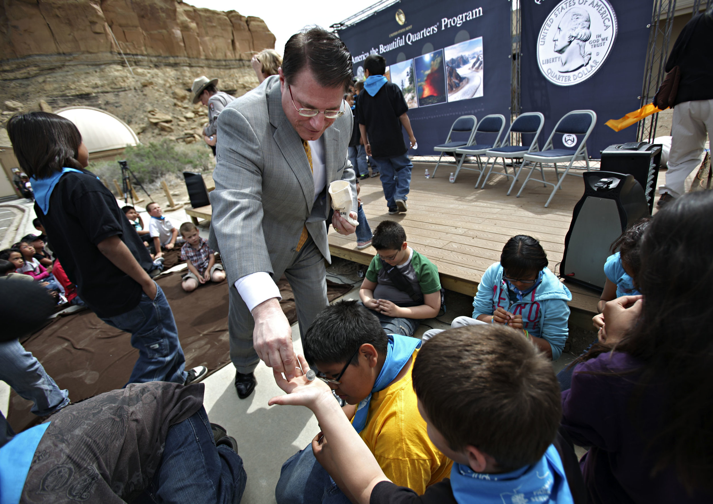  Deputy Director of the United State Mint Richard Peterson hands out Chaco Canyon quarters to 5th graders from Apache Elementary during the quarter launch at Chaco Canyon, Thursday, April 26, 2012. (Morgan Petroski/Albuquerque Journal) 
