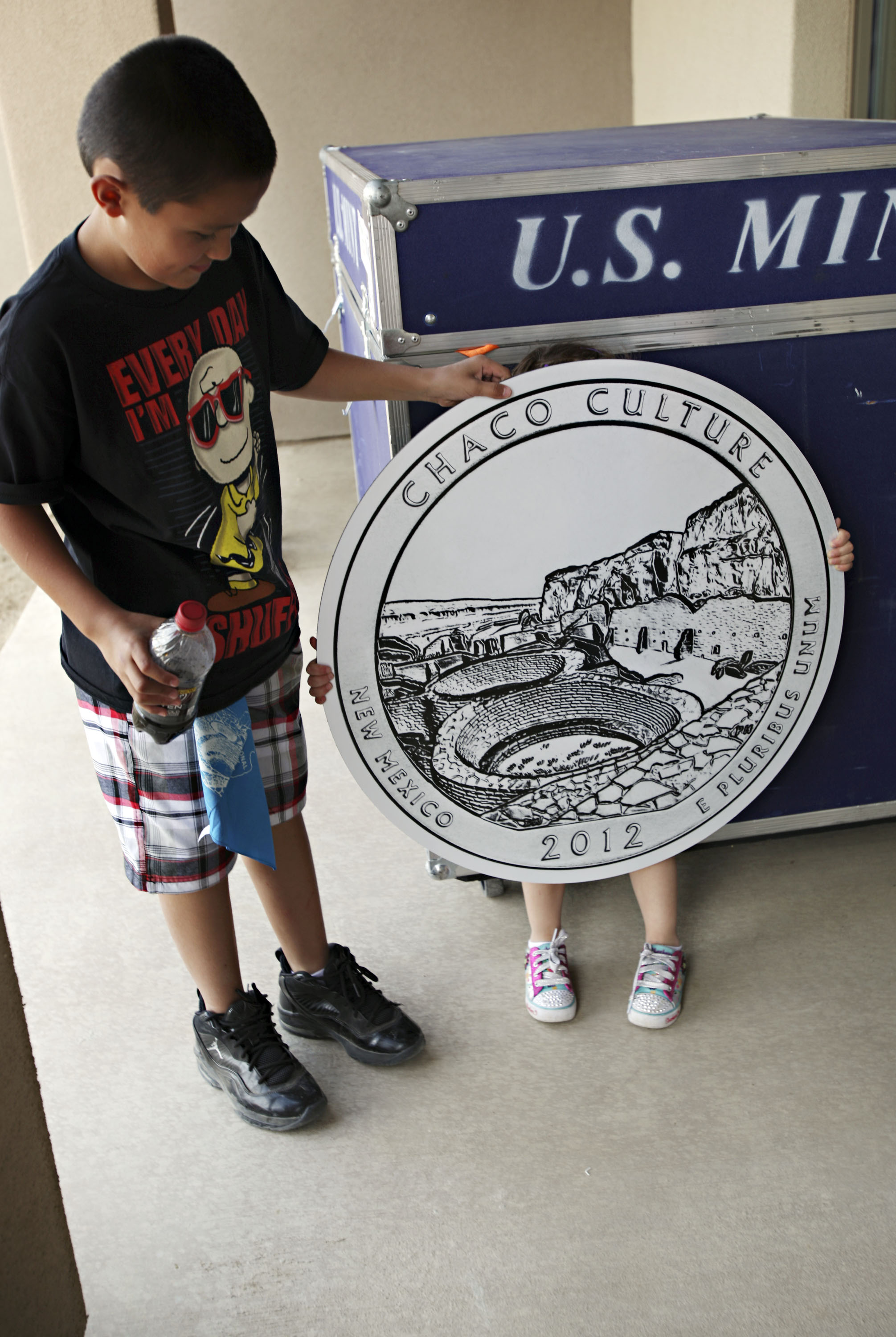  Peyton Gallegos, 3, hides behind the Chaco Canyon quarter prop after posing for a photo with her brother, Timothy Gallegos, 11, after the official quarter launch at Chaco Canyon, Thursday, April 26, 2012. The children were visiting with their mother