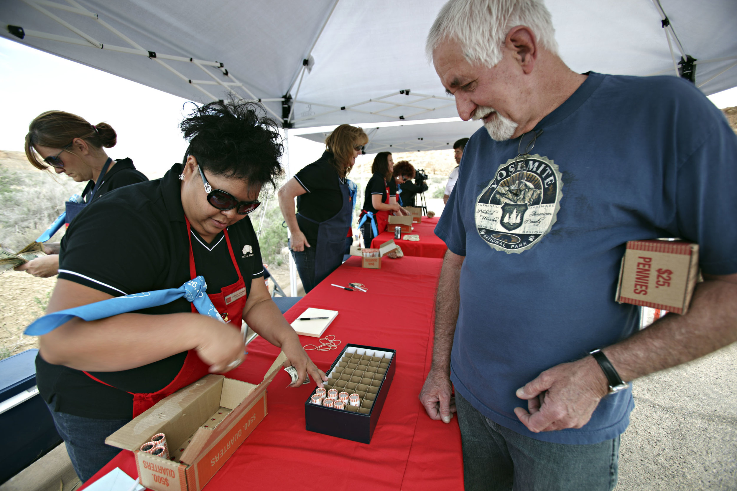  Gallup Wells Fargo store manager Melanie Mitchell exchanges 10 rolls of $10 quarters for coin collector Jon Brackin, from Las Vegas, Nevada, during the quarter launch at Chaco Canyon, Thursday, April 26, 2012. Brackin said he has been to 6 of the 8 