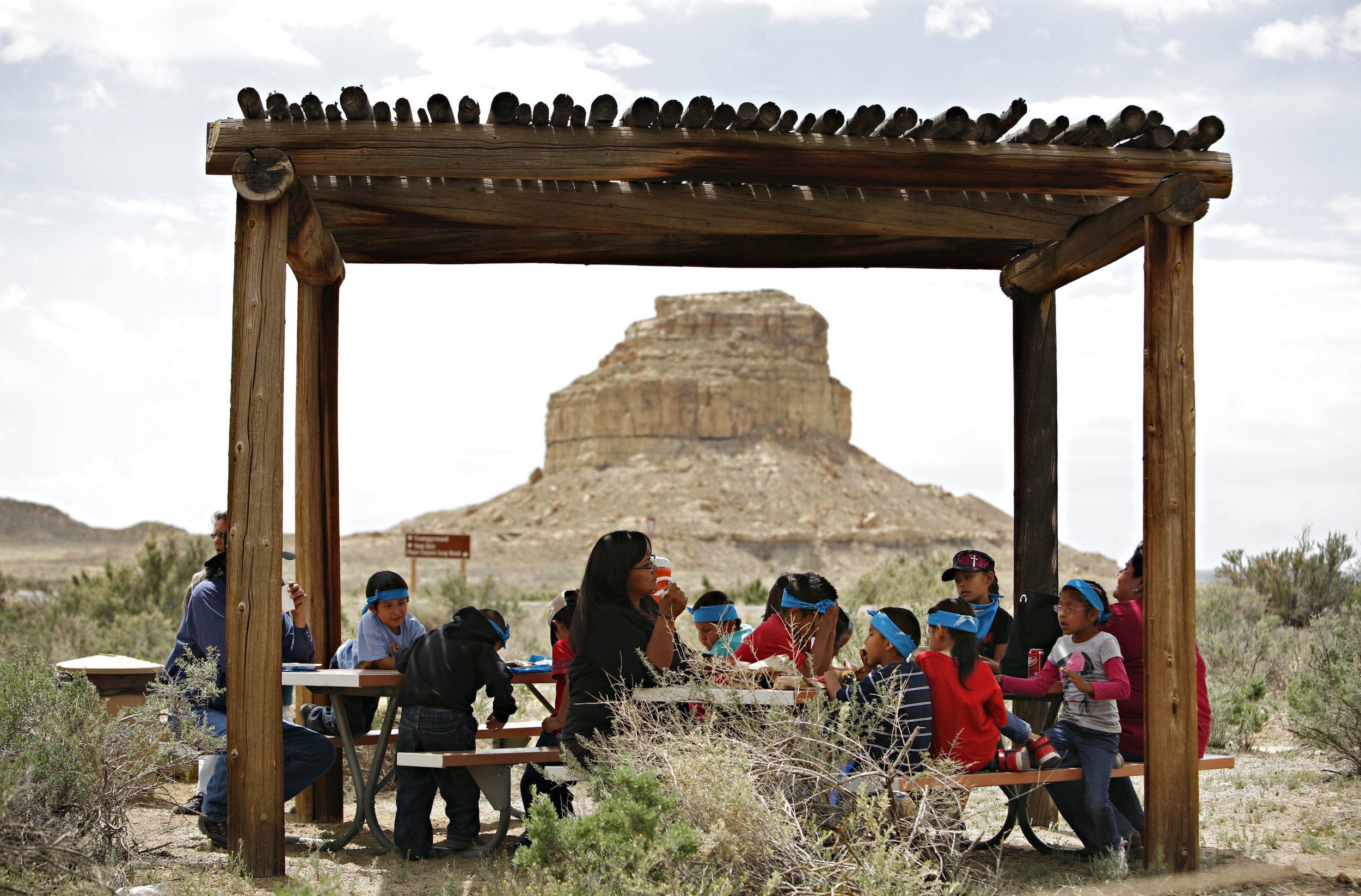  Children from Hanaa'dli Community School eat lunch outside the new visitor center at Chaco Canyon and in front of Fajada Butte, Thursday, April 26, 2012. (Morgan Petroski/Albuquerque Journal) 