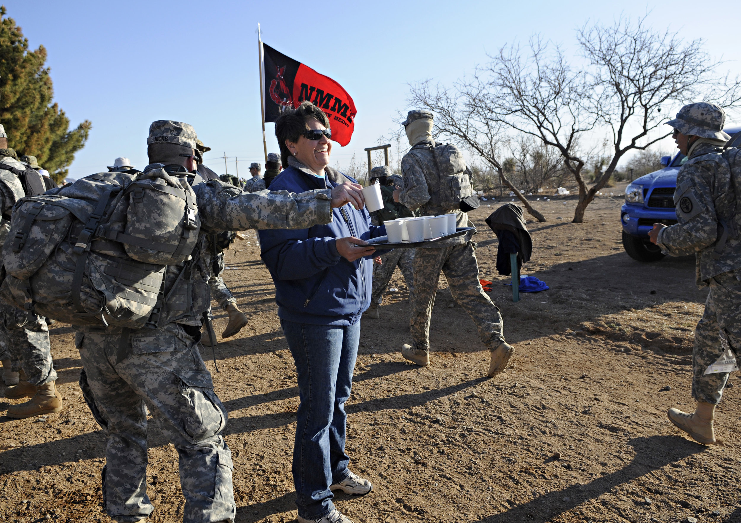  Volunteer Vicki Anderson, from Las Cruces, holds out water for the walkers and runners during the 22nd Annual Bataan Memorial Death March at White Sands Missile Range, Sunday, March 27, 2011. (Morgan Petroski/Albuquerque Journal) 