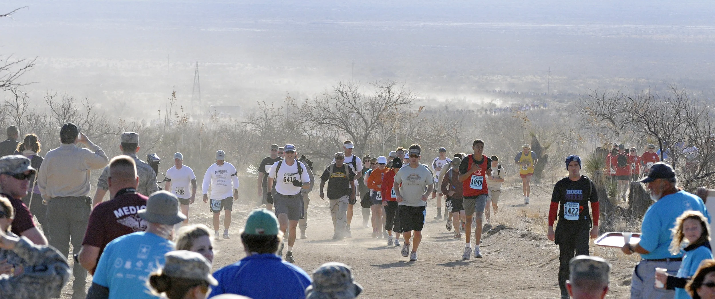 Walkers and runner emerge from the dusty desert of White Sands Missile Range during the 22nd Annual Bataan Memorial Death March, Sunday, March 27, 2011. (Morgan Petroski/Albuquerque Journal)