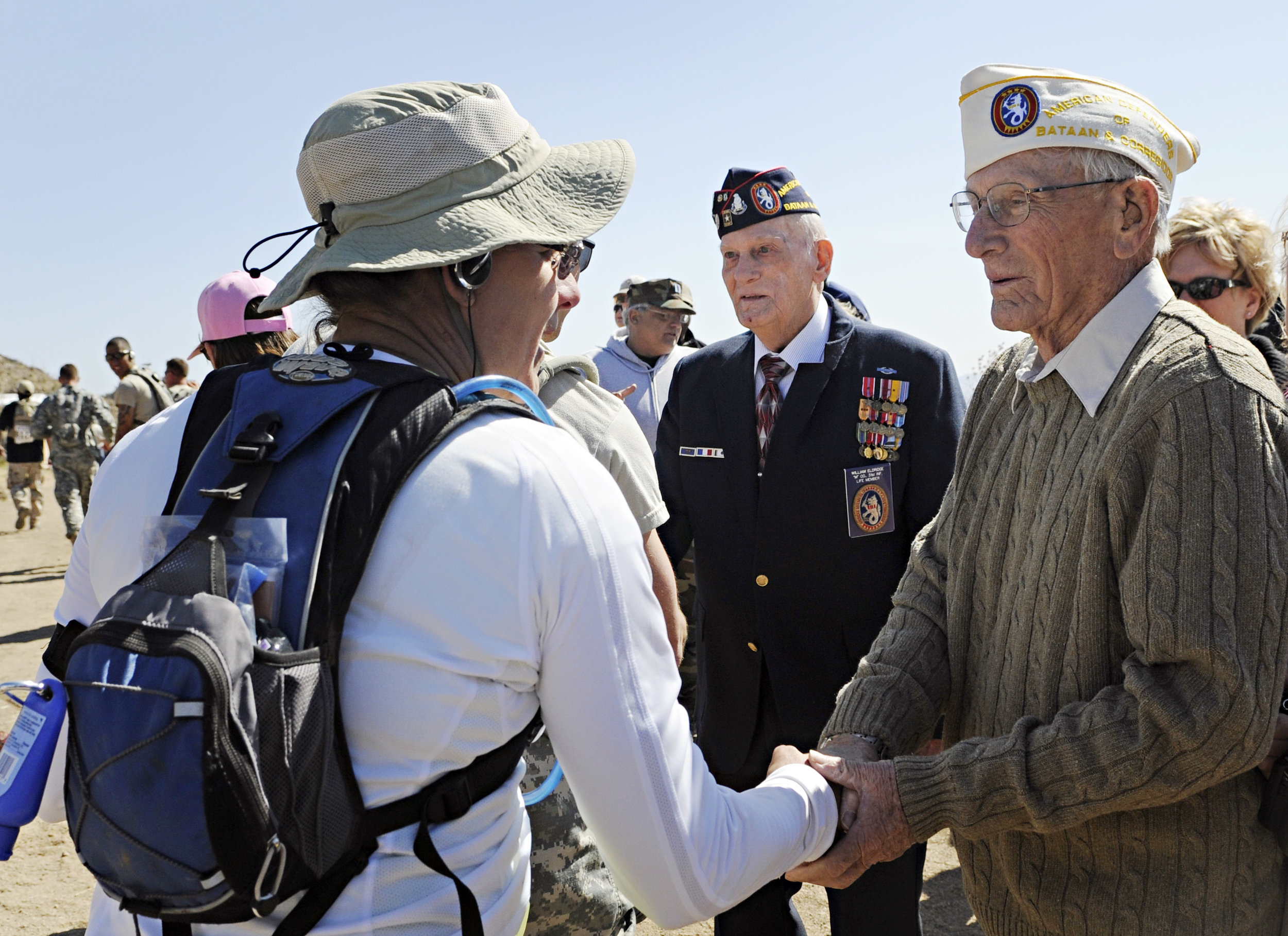 Bataan survivors Harold Bergbower, 90, from Peoria, AZ, at right, and William Eldridge, 88, from Citrus Heights, CA, greet runners at water point 7 during the 22nd Annual Bataan Memorial Death March at White Sands Missile Range, Sunday, March 27, 20