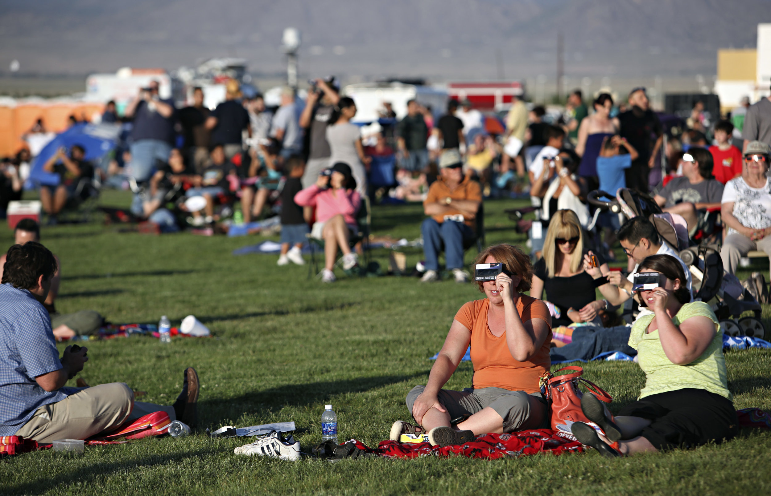  From right, Deanna Creighton and Crystal Humble, both from Albuquerque, watch the annular solar eclipse during the eclipse viewing party near the Hard Rock Casino Presents the Pavilion, Sunday, May 20, 2012, in Albuquerque, NM. (Morgan Petroski/Albu