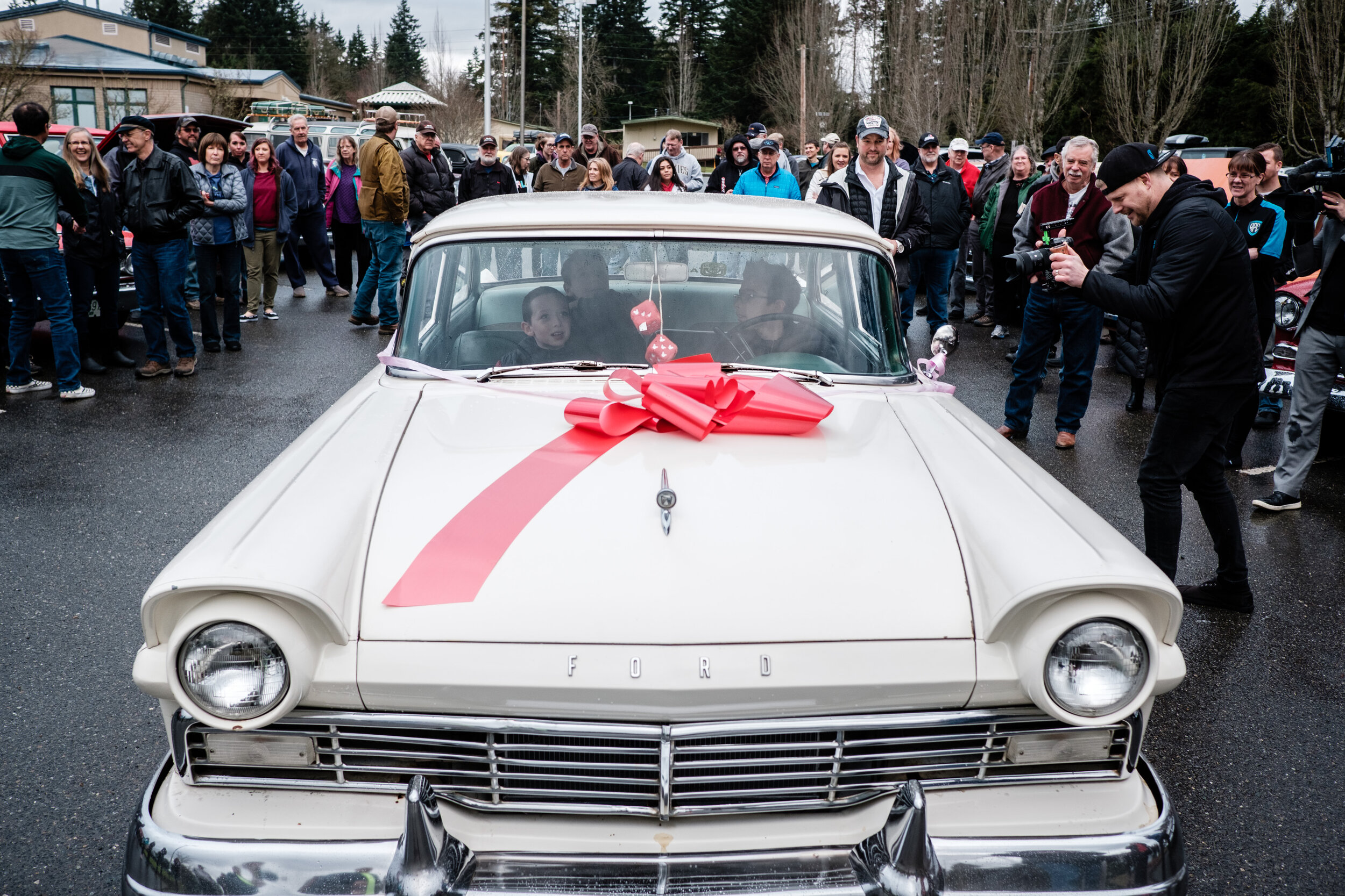 Woodinville Car Club and friend gather around Anthony's new car.