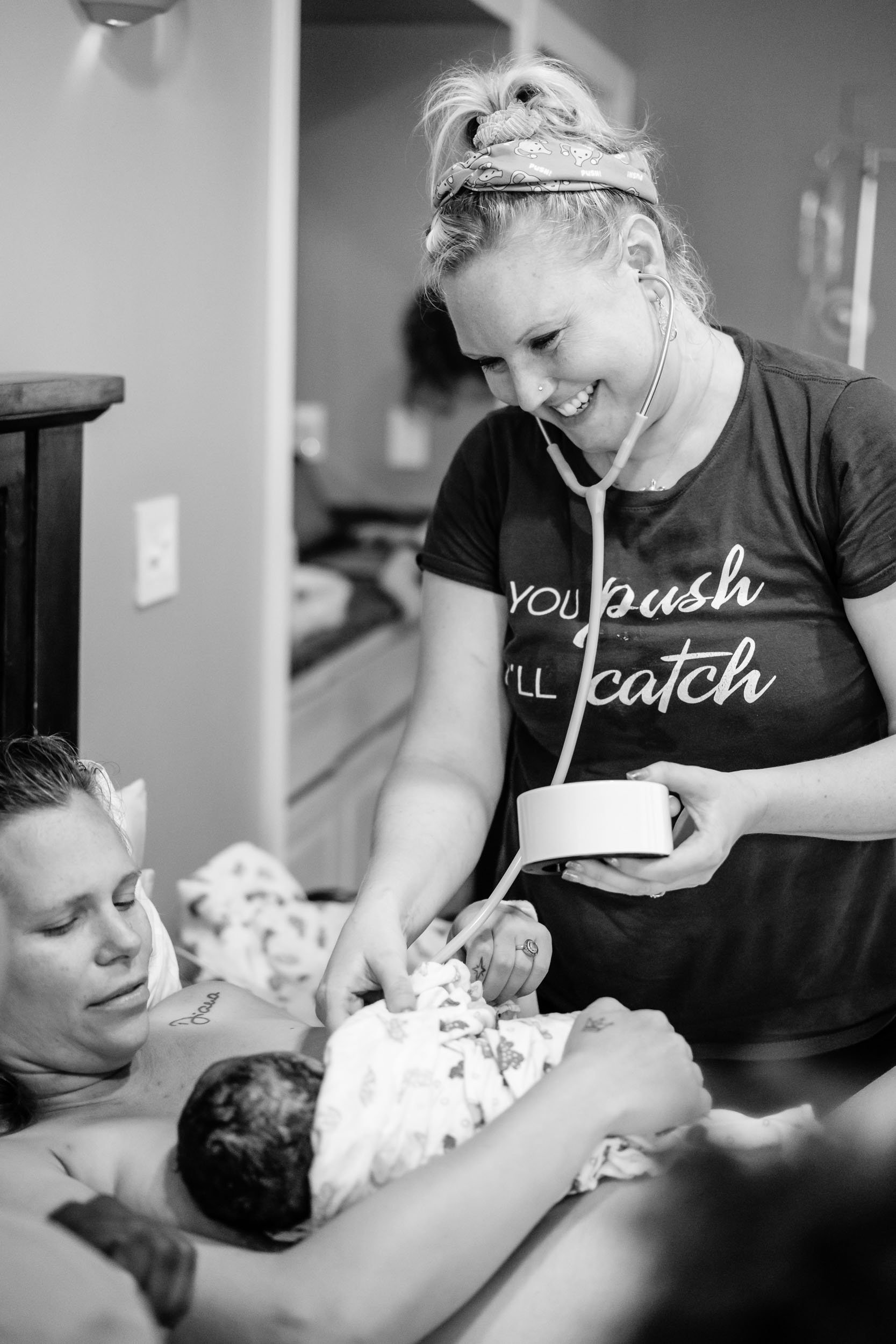 Puget Sound Birth Center midwife cares for baby and mother immediately after birth.