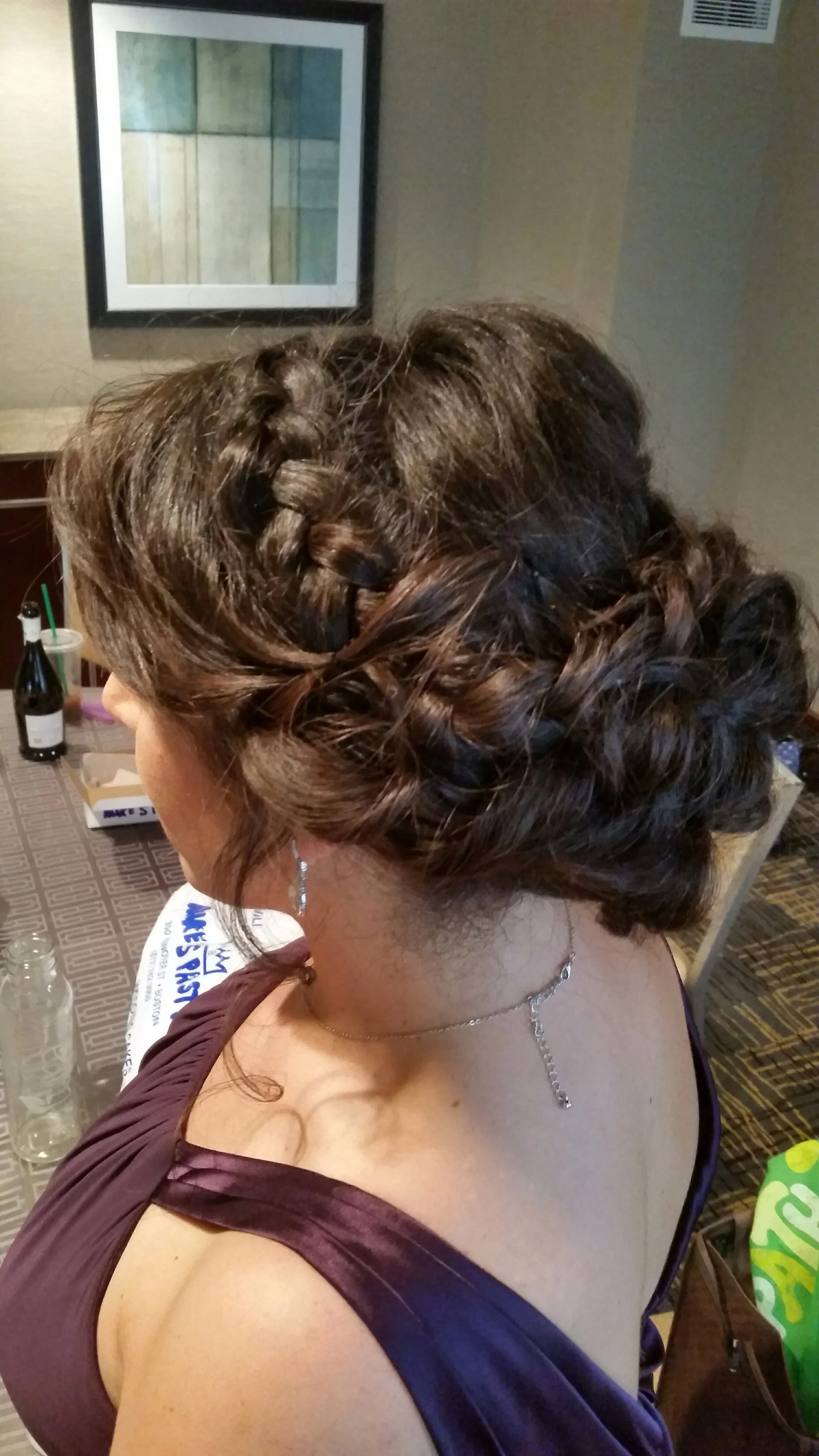 Bridesmaid with a low messy updo with a Dutch braid