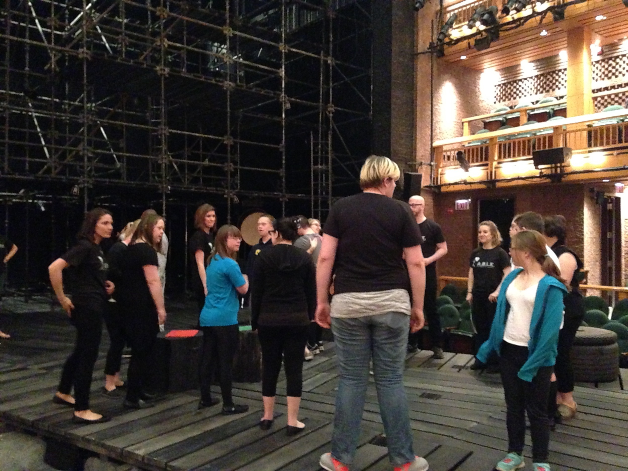 Everyone gathers onstage to warm up.