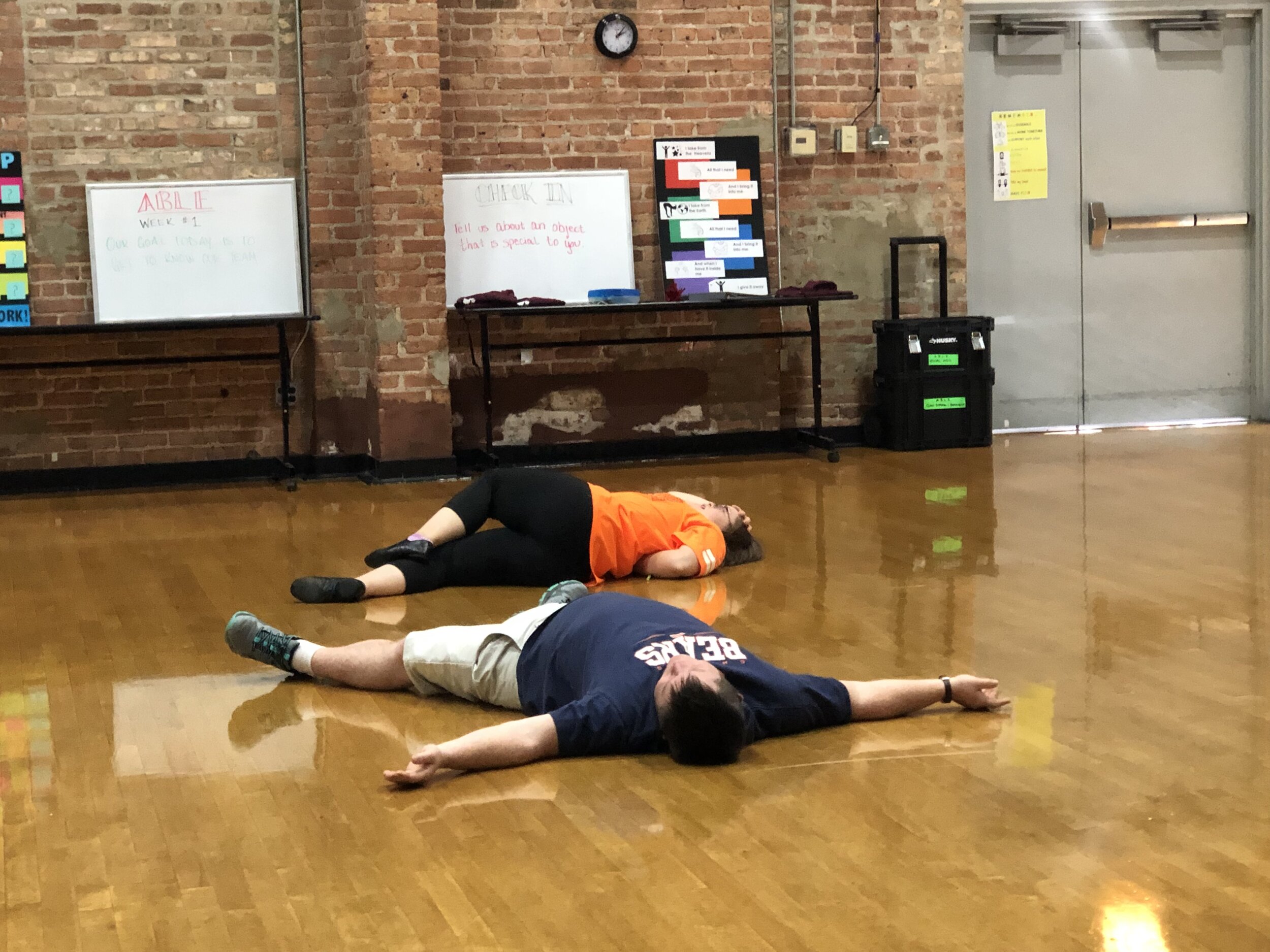 Emily and Matthew lay on the floor after a failed swimming attempt in their scene