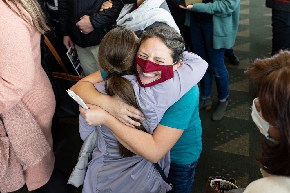  Virtual ensemble member Natalia, and Executive Artistic Director Katie share an excited hug in the lobby 