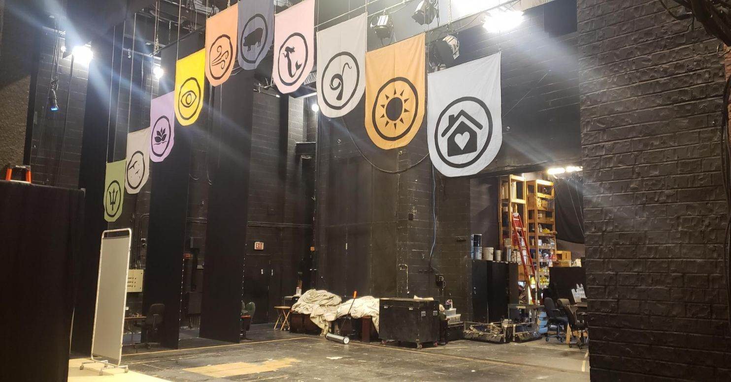 It's almost showtime! We're so excited to see these beautiful custom banners framing the stage at @chicagoshakes. Our Teaching Artist Emma MacLean is also a brilliant textile artist, and handmade these pendants based on our poster art for #OdysseyABL