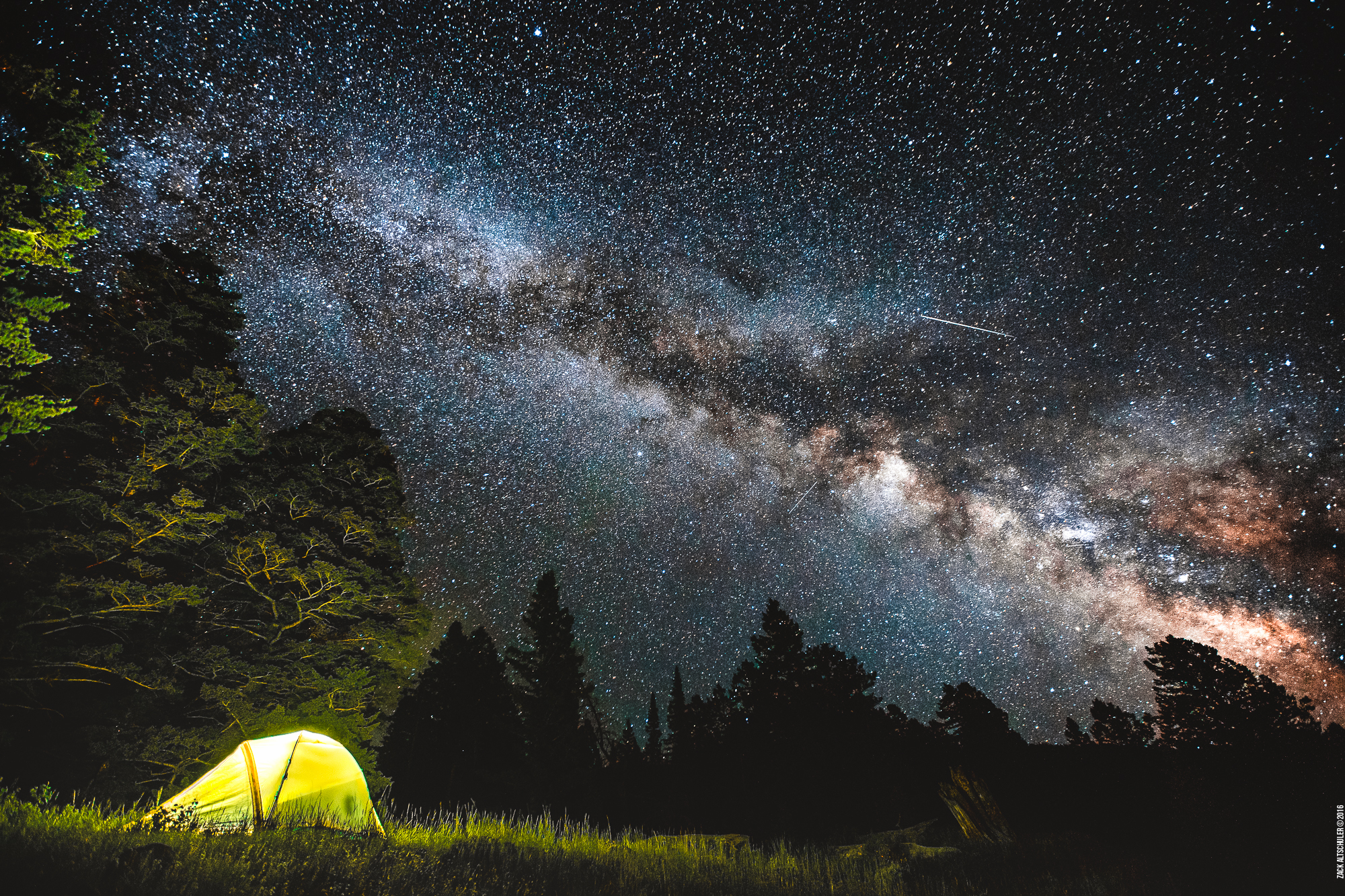Lit up tent under the Milky Way