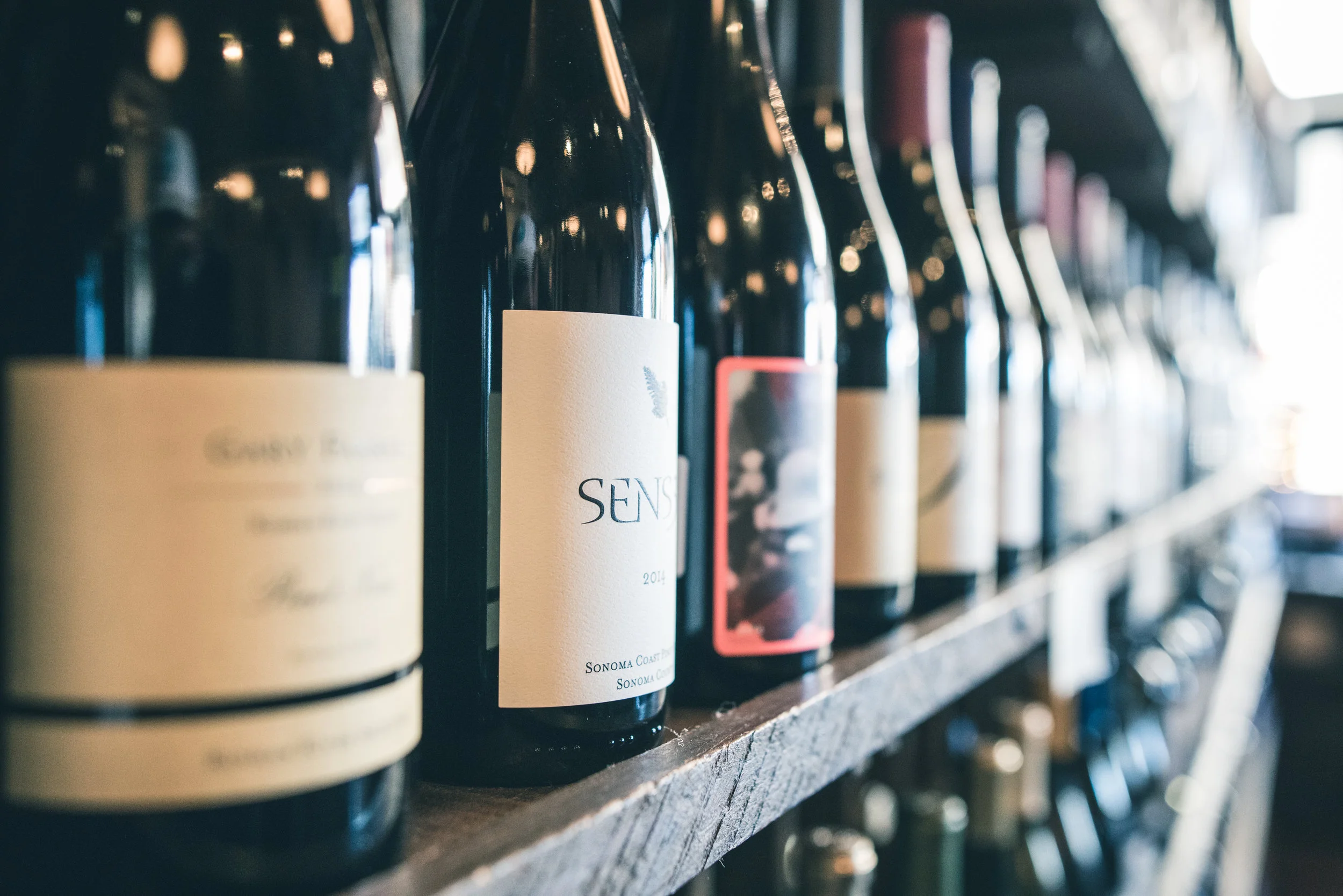 Shelf with wine bottles lined up