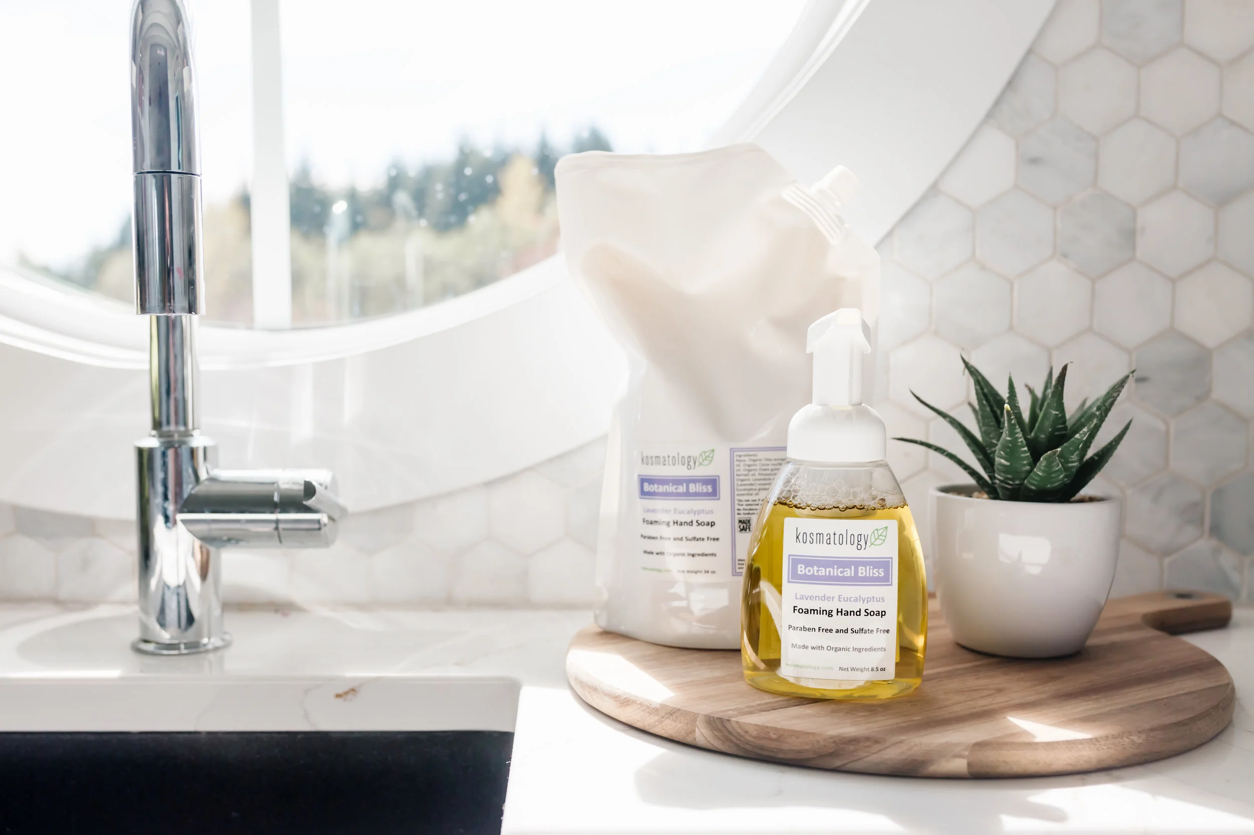 Botanical Bliss Hand Soap and Refill Bag pictured next to a kitchen sink