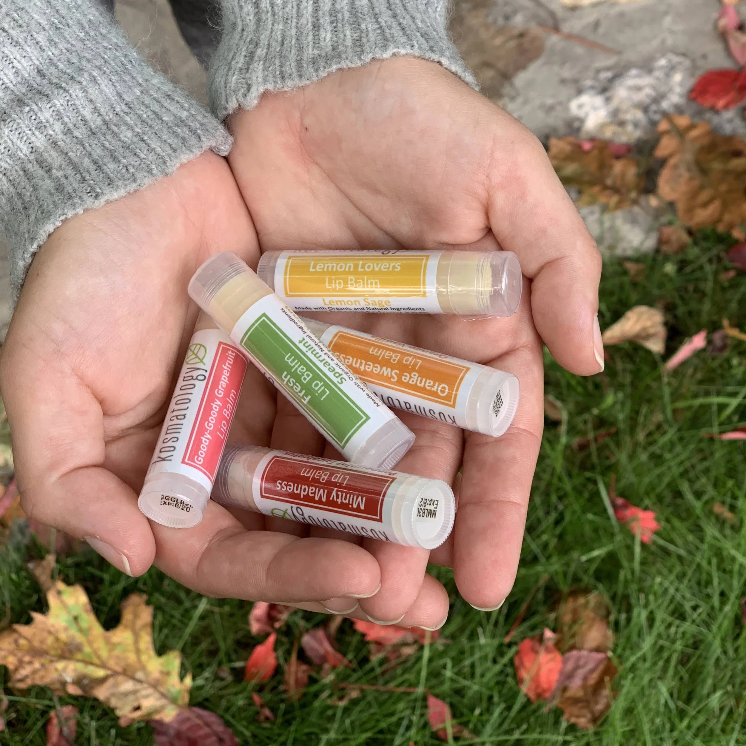 Kosmatology lip balms in open hands
