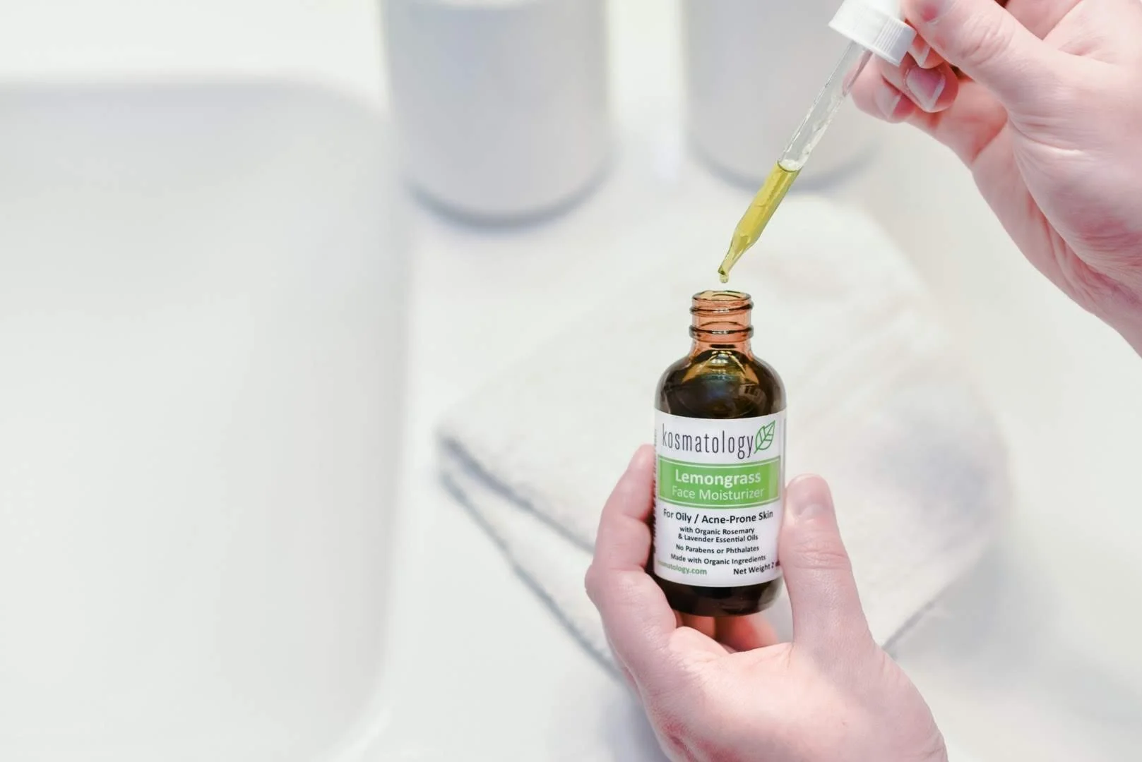 Lemongrass face oil dripping into the bottle from the pippette.