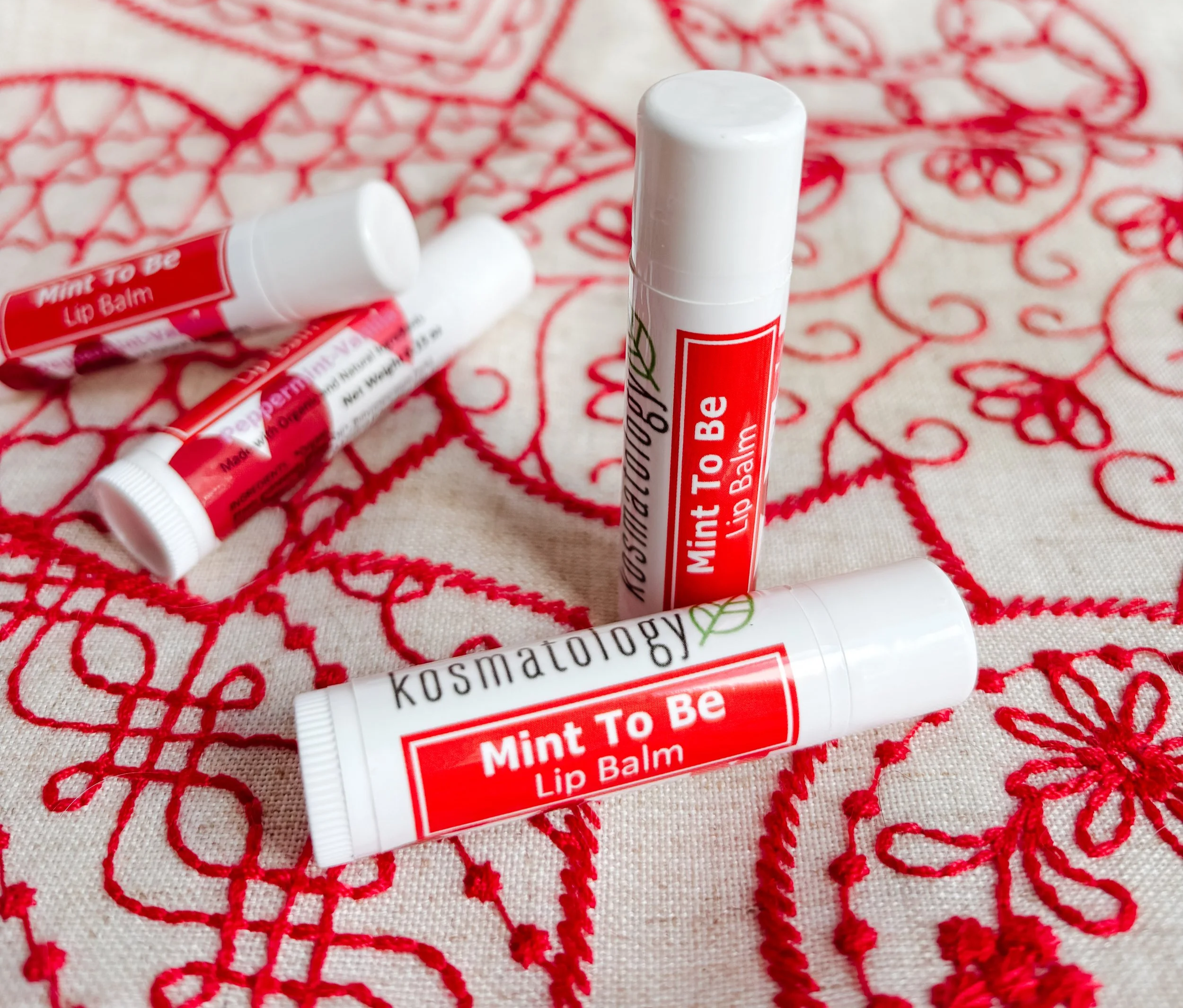 Mint to Be lip balm on a red patterned cloth