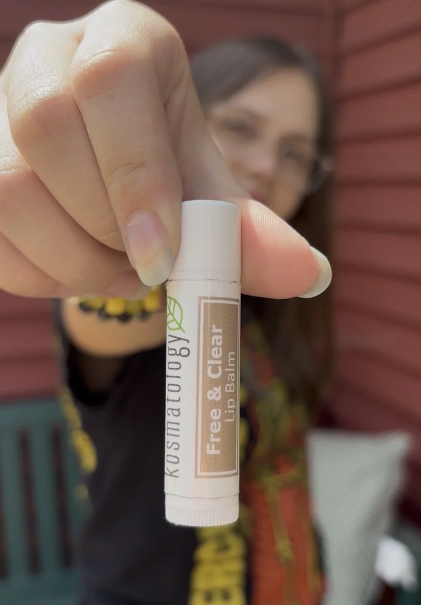 Girl holding Kosmatology Free & Clear Unscented lip balm