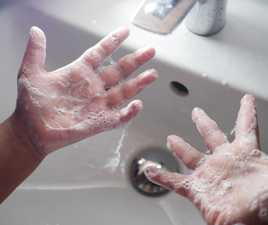child's hands covered in soap bubbles