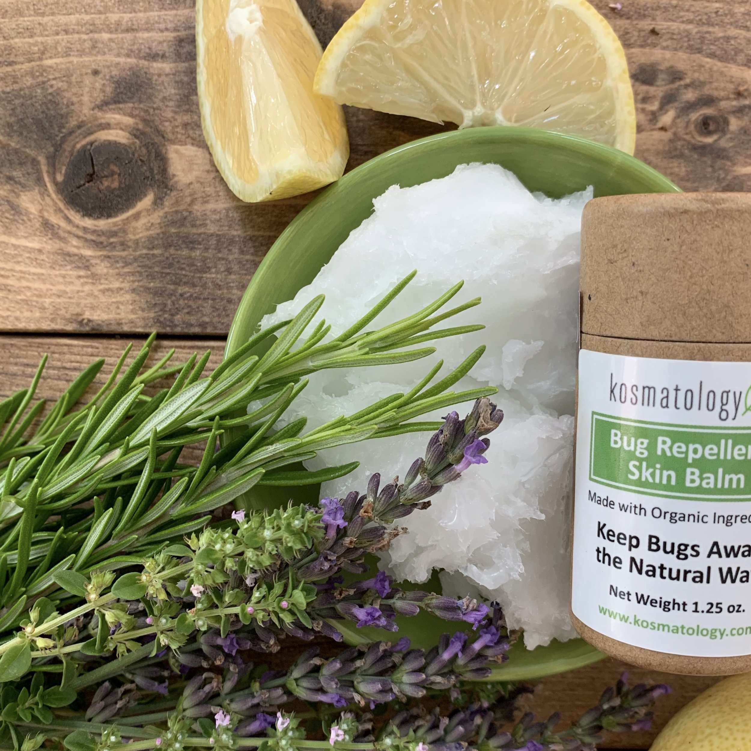 Natural mosquito repellent surrounded by natural ingredients including coconut oil, rosemary, lavender and lemon.