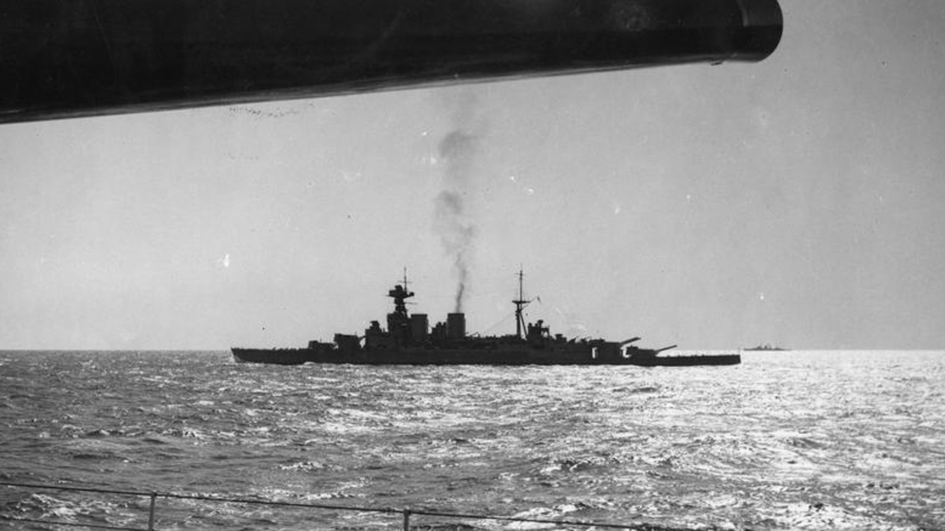 Imperial War Museum Photo: HU 76078 (Part of the Ministry of Information Second World War Press Agency Print Collection). The Royal Navy battleship HMS Hood in the middle distance viewed beneath the silhouetted 15" gun of HMS Renown. Photo taken by Topical press photographer.