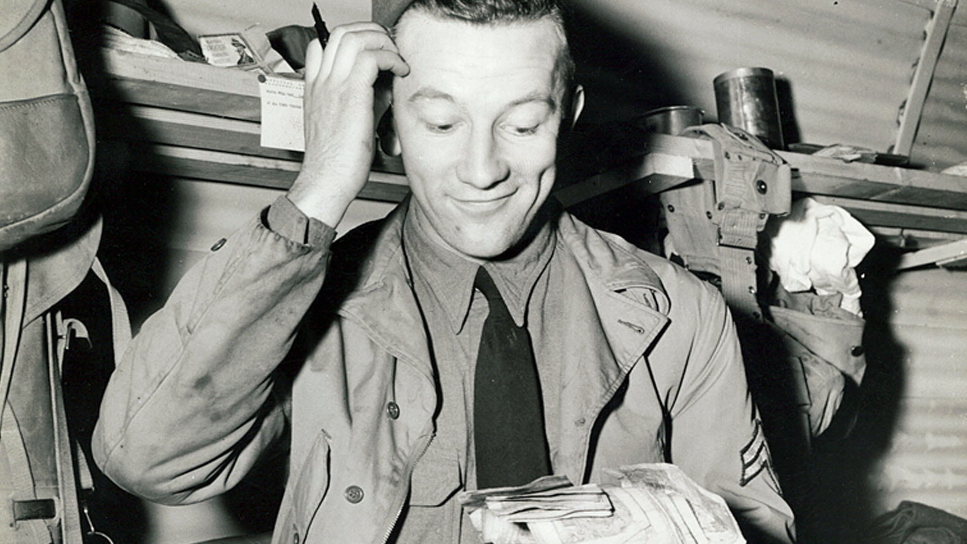 Washington County Free Library Photo WCRH019. Part of the General Russell P Hartle Collection. An American GI struggles to make head nor tail of British currency after the US Army’s first payday in Northern Ireland. Photo taken on 16th March 1942. Copyright United States Signal Corps.