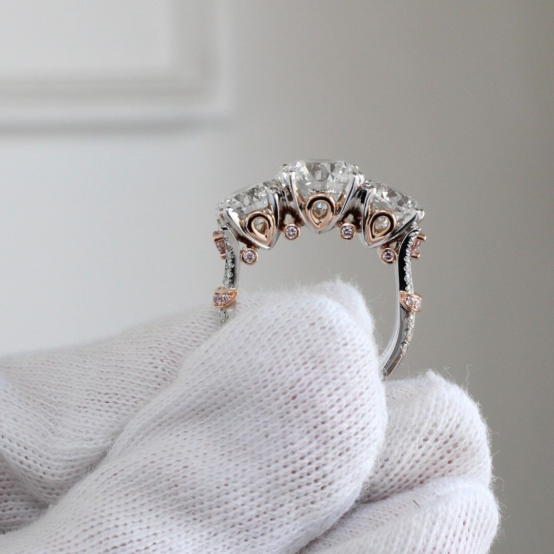 Pink diamonds and rose gold bring a beautiful warmth to this three stone diamond ring 😍