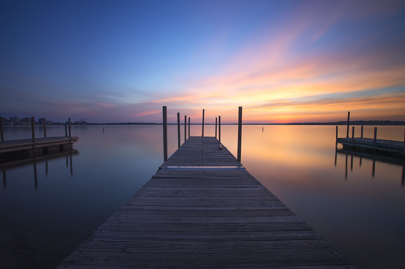 Nine minute exposure of sunrise over Lake Monona in Madison, Wisconsin. By stacking series of filters it's possible to achieve very long exposures, smoothing the water in the process.