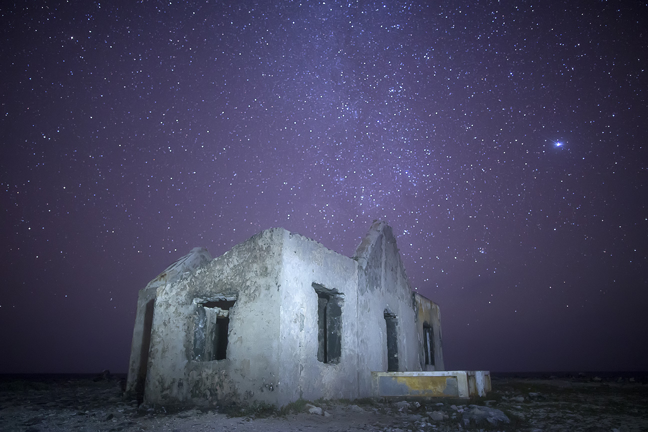 I recently shot these lighthouse ruins near the southern coast of Bonaire in the Dutch Caribbean. When initially shot, the stars looked great but the building was underexposed. "Painting" it with a flashlight during the long exposure did the trick.