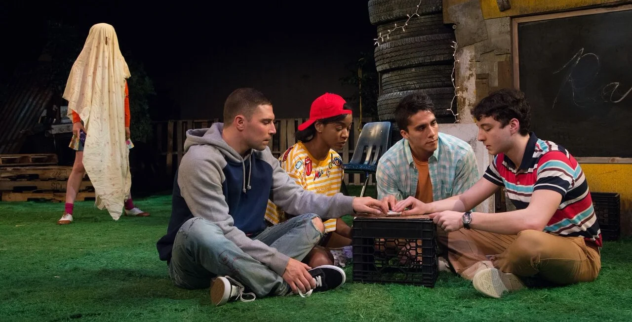 The gang dabbles in the dark arts with a Ouija board. (Photo by Johanna Austin)