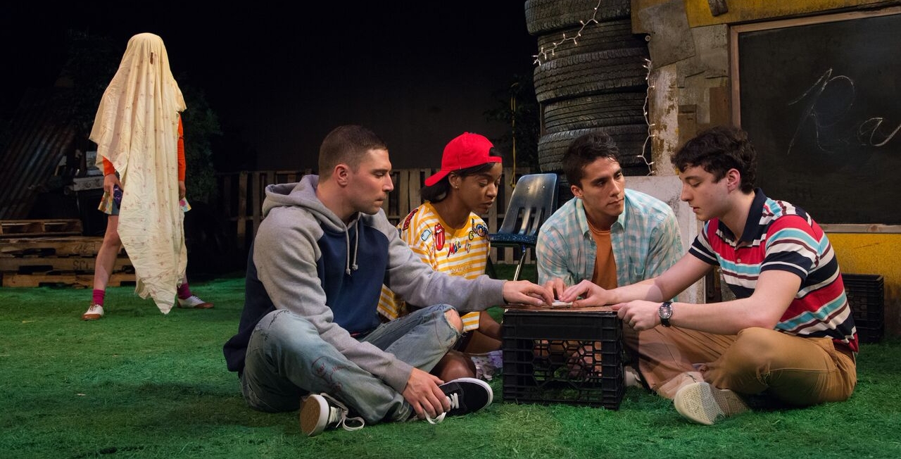 The gang dabbles in the dark arts with a Ouija board. (Photo by Johanna Austin)