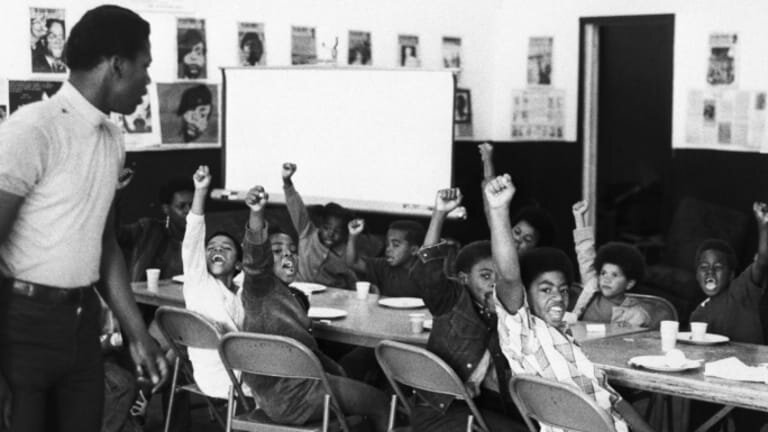 Children receive free breakfast from members of the Black Panther Party // Photo courtesy of History.com
