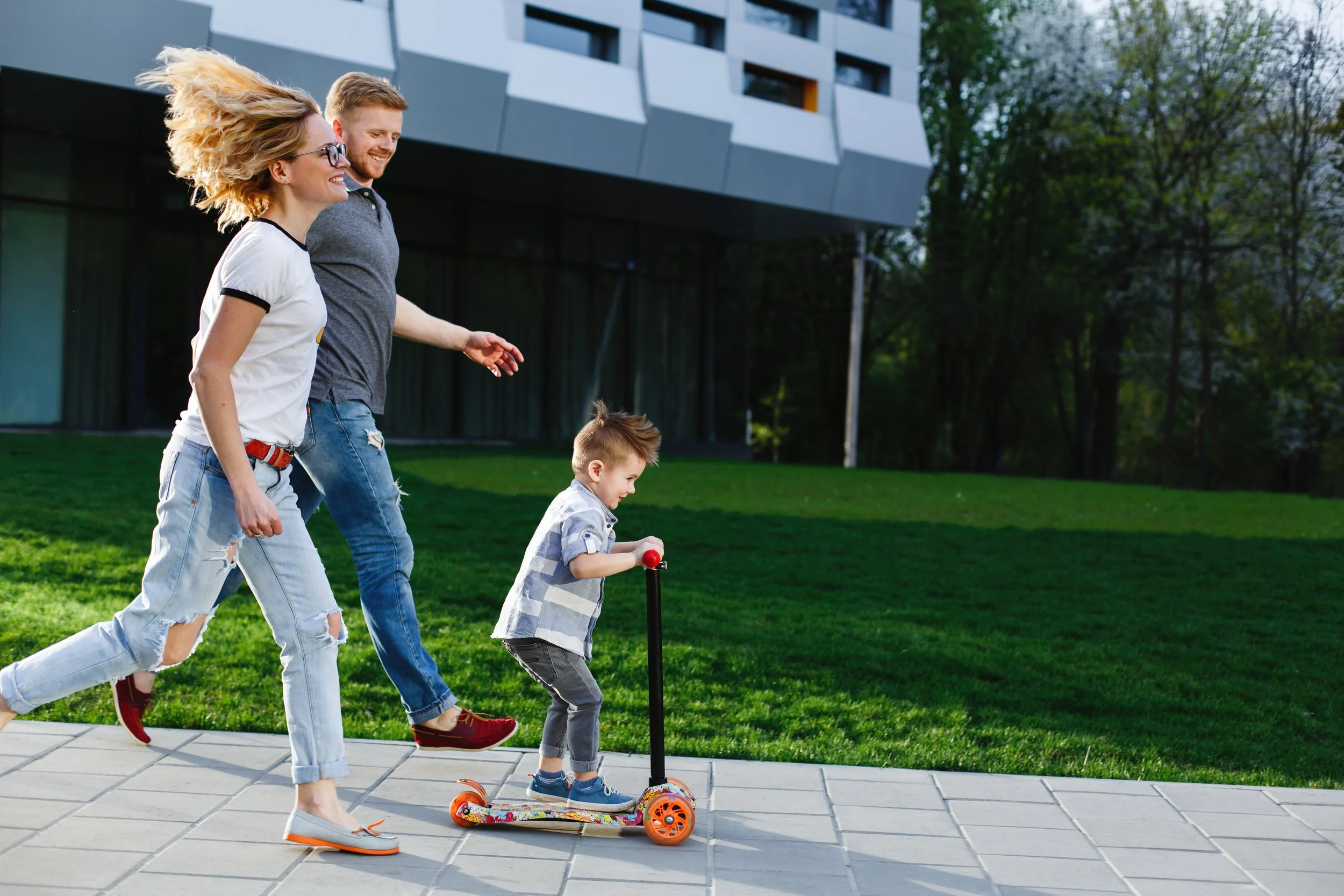 mom-dad-run-their-son-while-he-rides-scooter.jpg