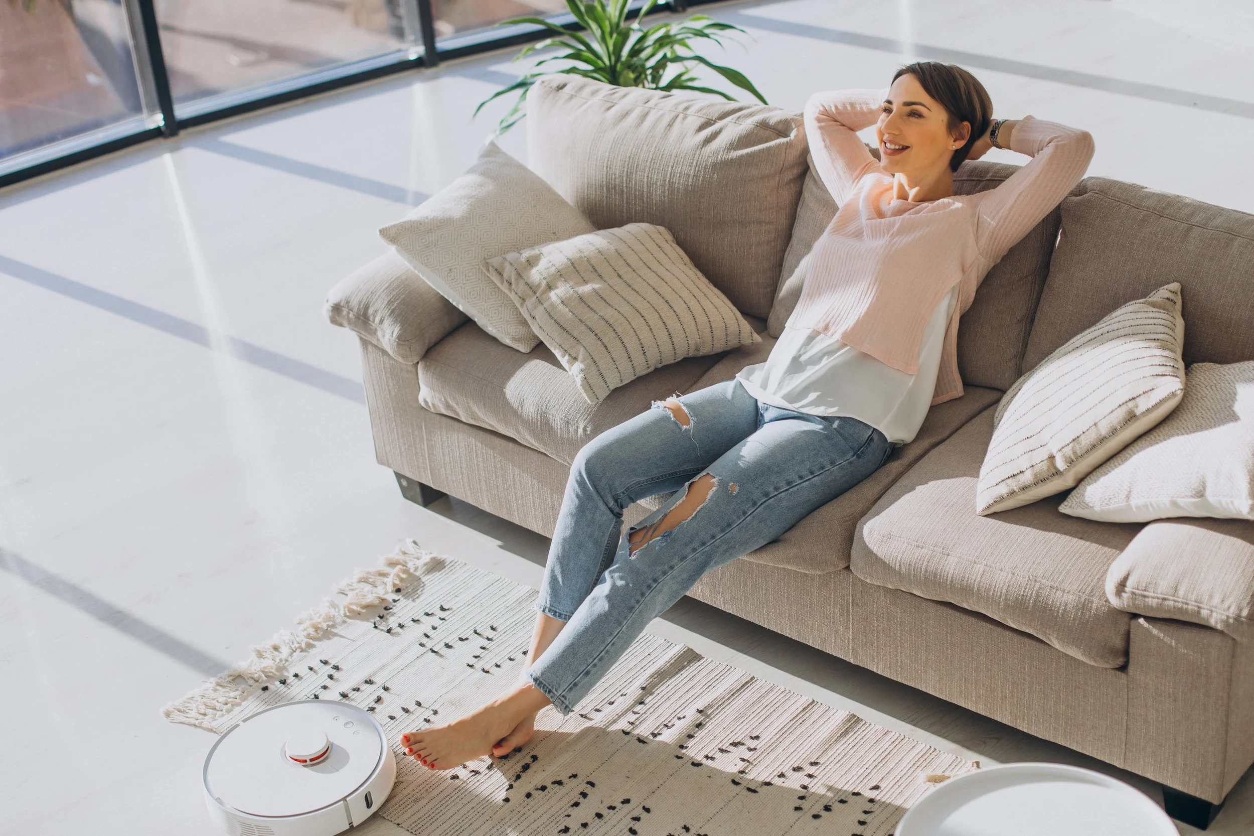 woman-relaxing-sofa-while-robot-vacuum-cleaner-doing-housework.jpg