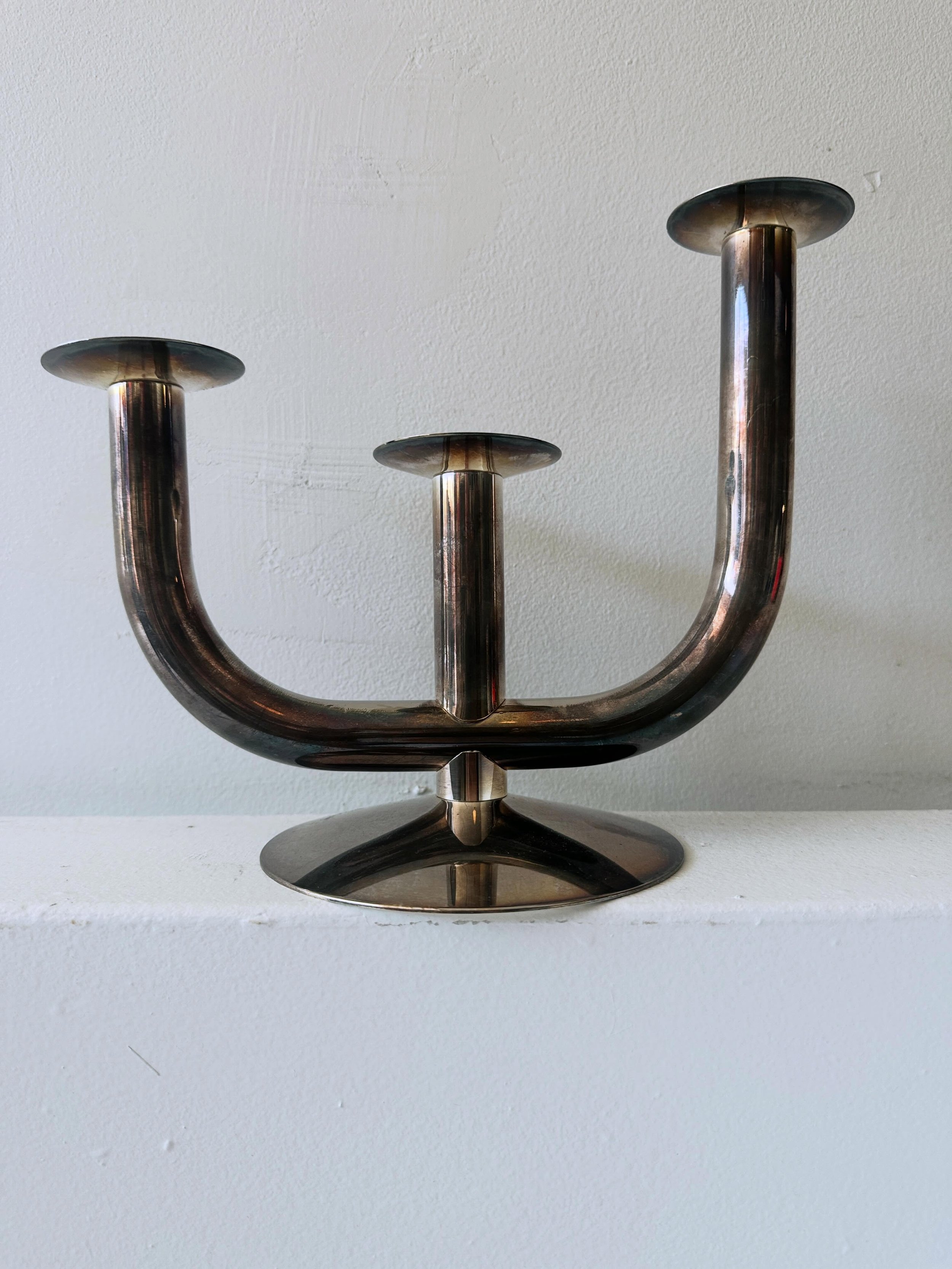 A very high quality mid century Italian candelabra.  Small tops can be removed to use separately.  This is some iteration of the Taurus design by Walter Von Nessen.  Elegant piece&hellip;silver plate over brass and with some sort of hallmark as well 