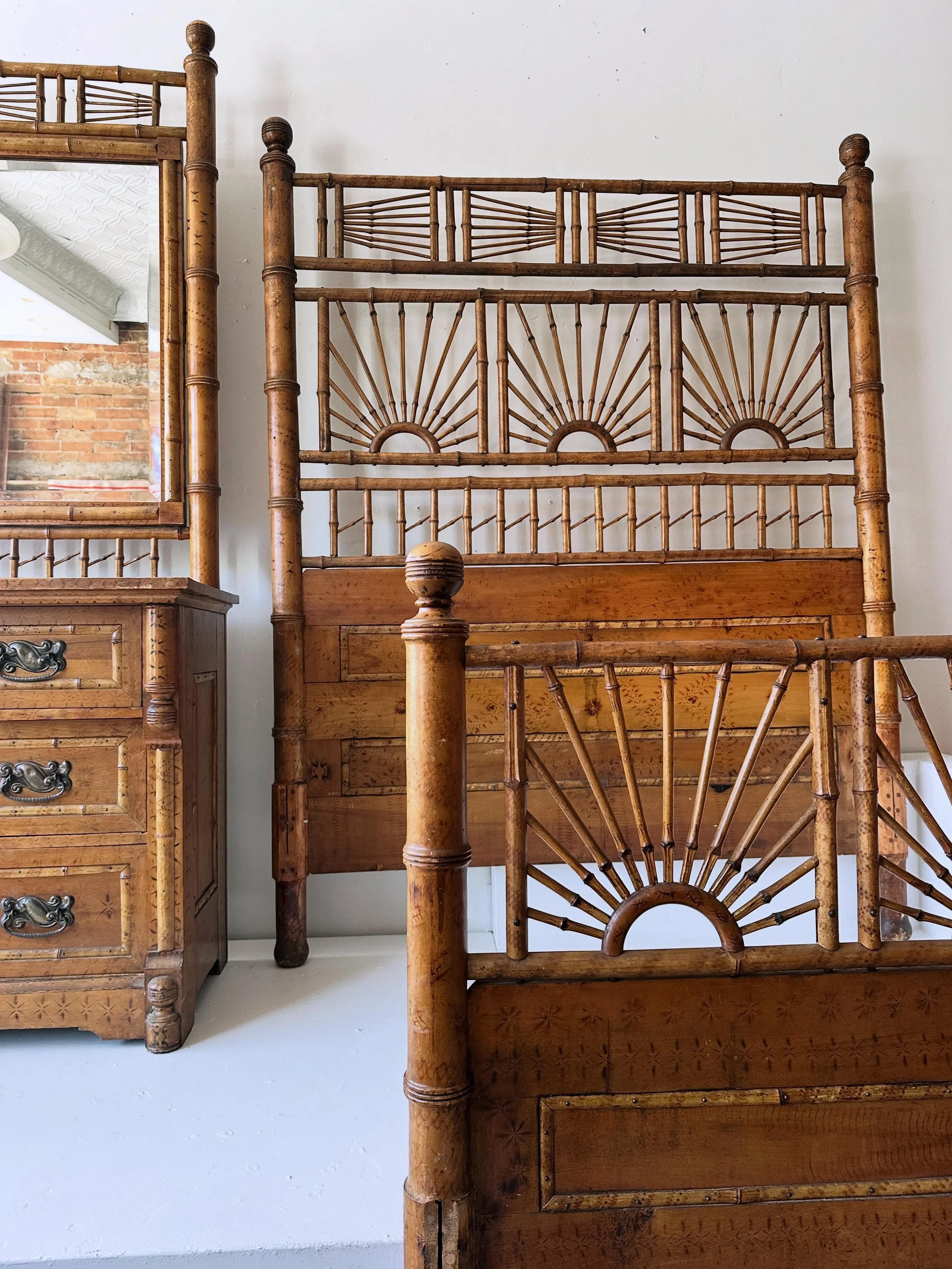 Spectacular Victorian bamboo and faux bamboo bedroom set. Features large three-drawer dresser with beveled mirror, an impressive double bed frame, and a chair.  Bed is complete with rails.  Dresser has recessed panels on the sides.  All-over stencill