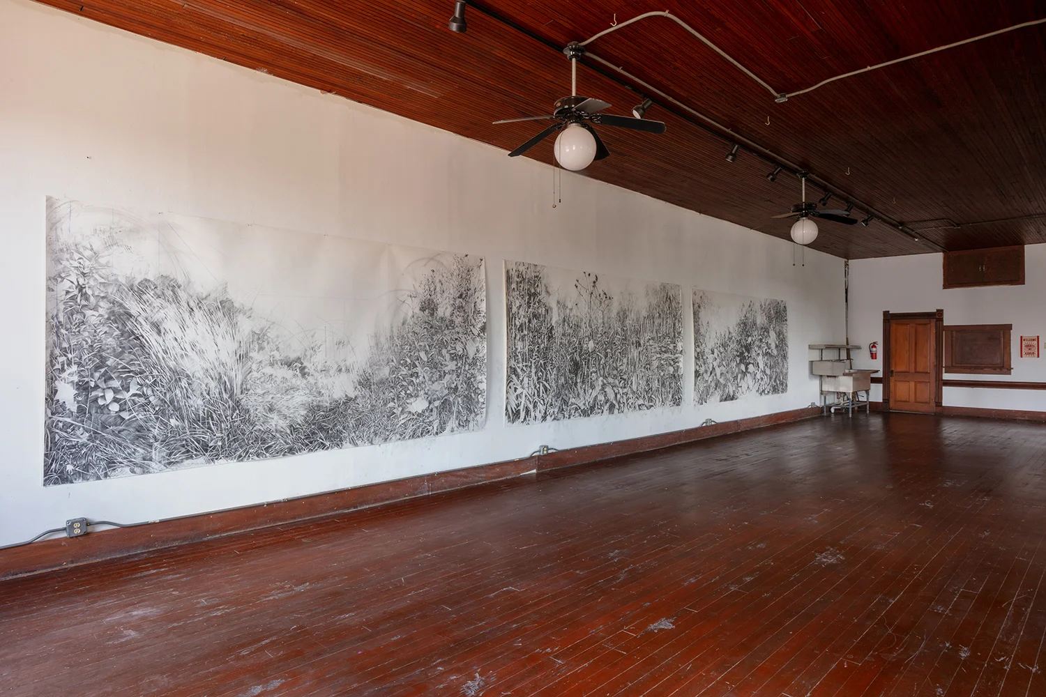 Voids . Installation at 100W Corsicana, 2019, graphite and pigment on paper, 6 x 36 feet- Image by Kevin Todora