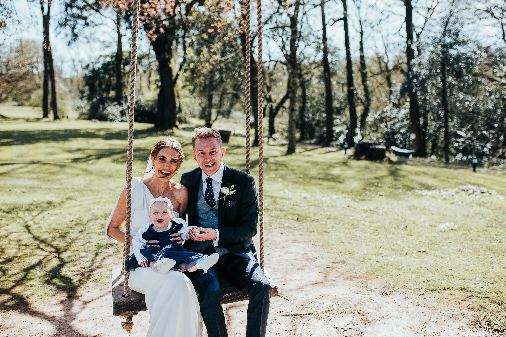 Wedding couple with baby on swing