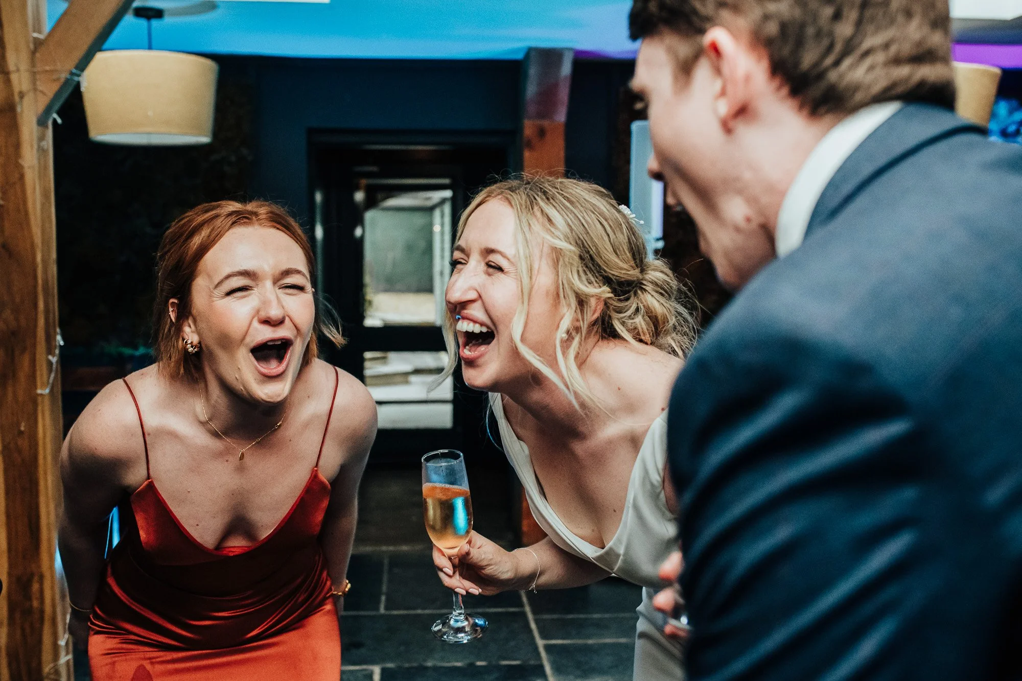 People laughing at an indoor event.