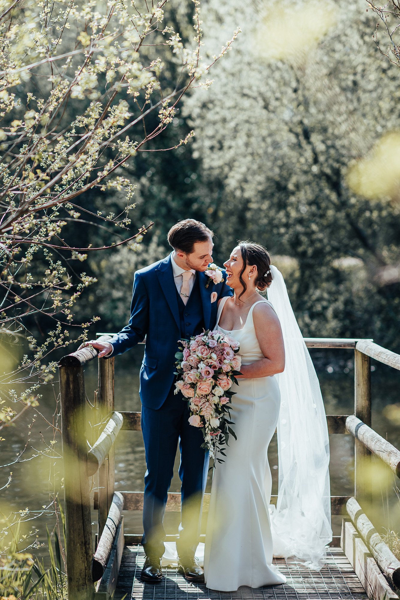 Bride and Groom laughing on their wedding day at Llanerch Vineyard