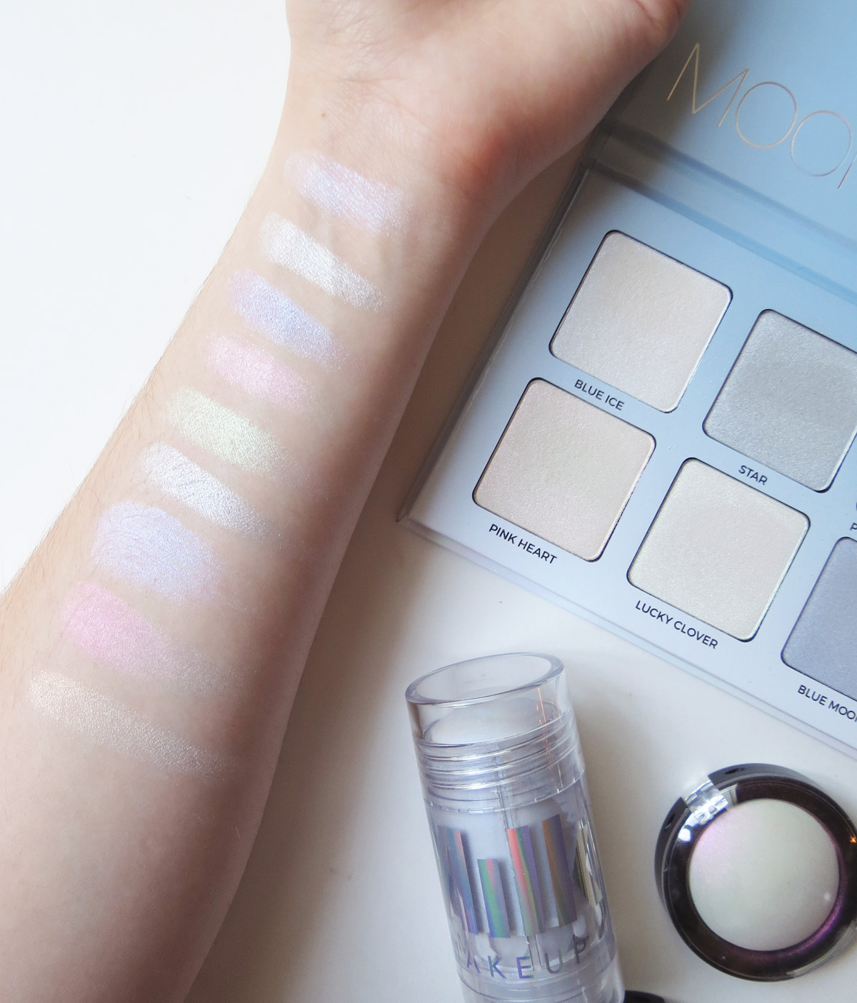 Top to Bottom: Moonchild Glow Kit (Blue Ice, Star, Purple Horseshoe, Pink Heart, Lucky Clover, Blue Moon), Milk Makeup Holographic Stick, Pat McGrath Skin Fetish, Kat Von D Thunderstruck