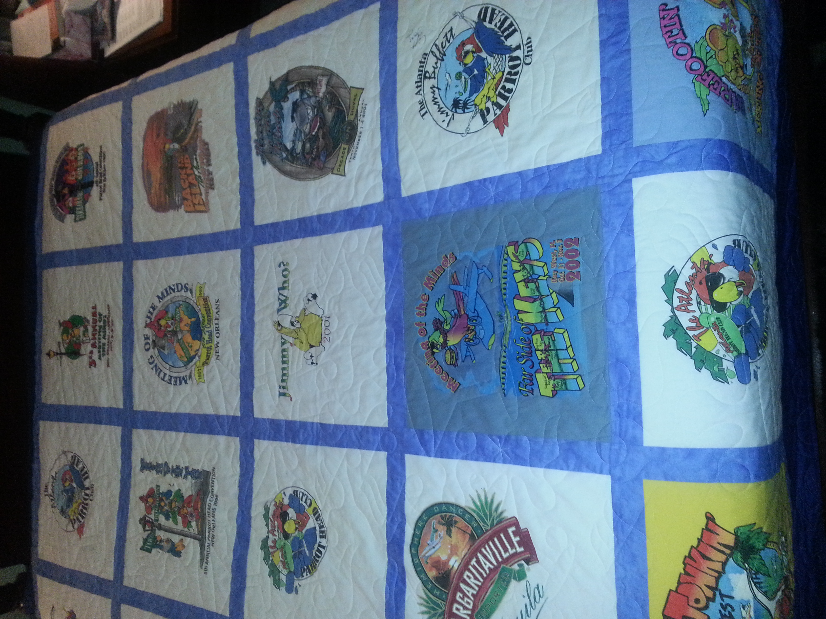 Parrot Head T-Shirt Quilt. Designed and constructed using 25 T-shirts and quilted using music notes and martini glasses. 