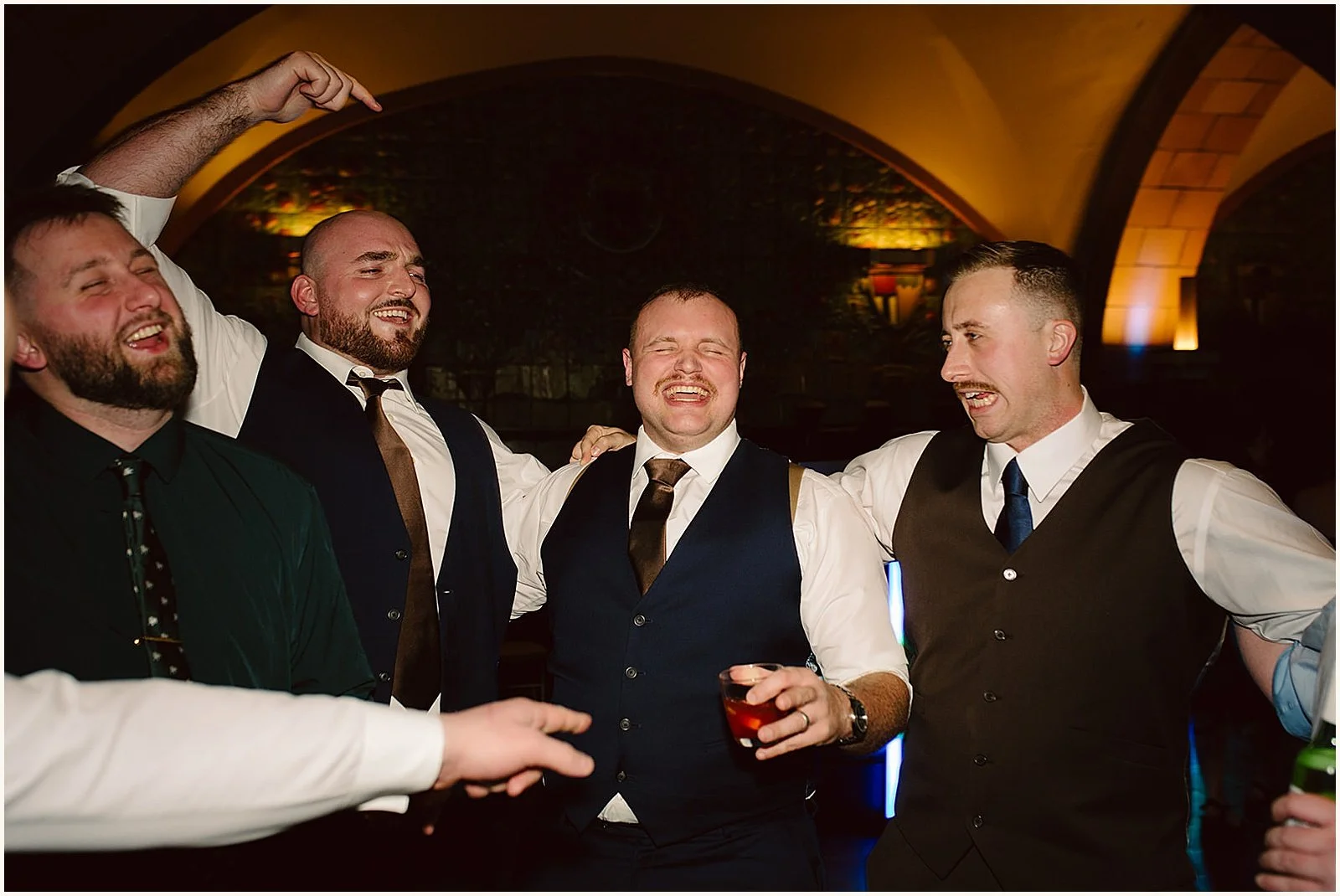 A groom dances with friends.