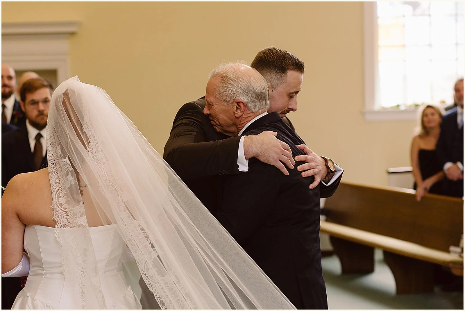A groom hugs his father-in-law inside a Louisville church.