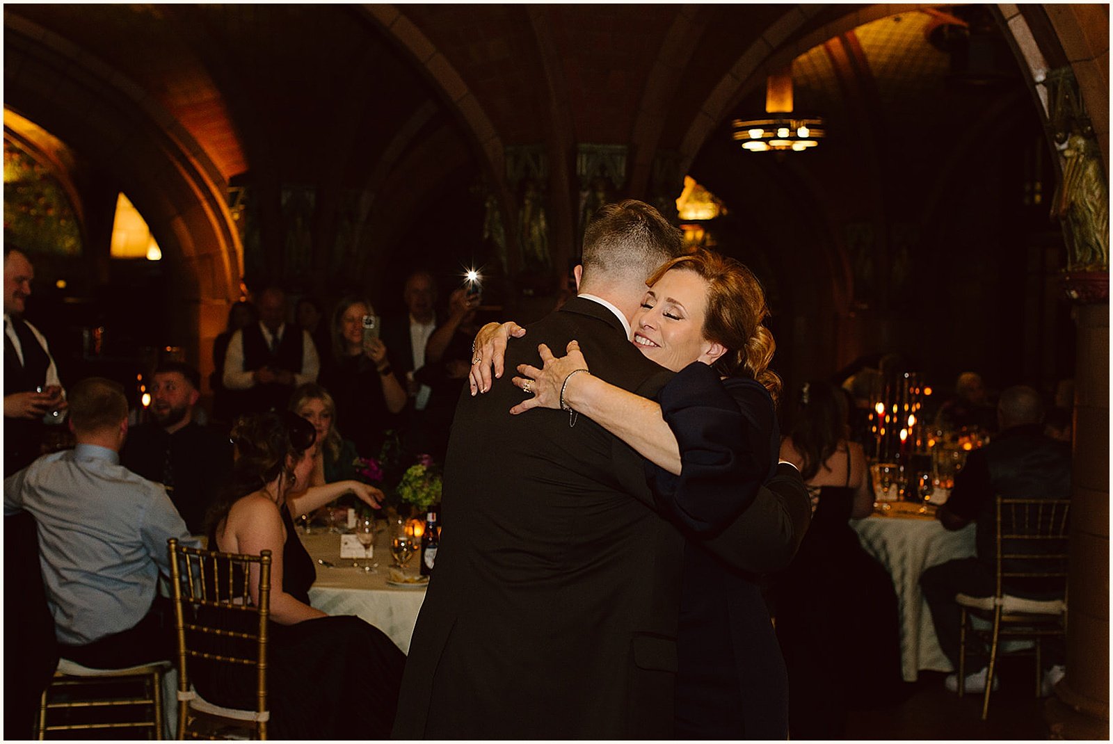 A groom dances with his mother.