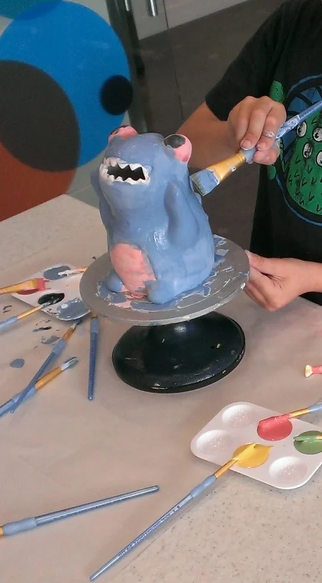 My son's froggy piggy bank masterpiece in it final stages. Make Meaning glazes it and fires it, then you pick it up in 4 days.