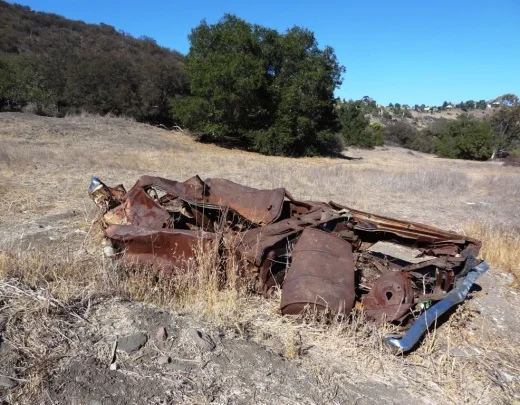 Demolished car sitting near Westlake Vista Trail.