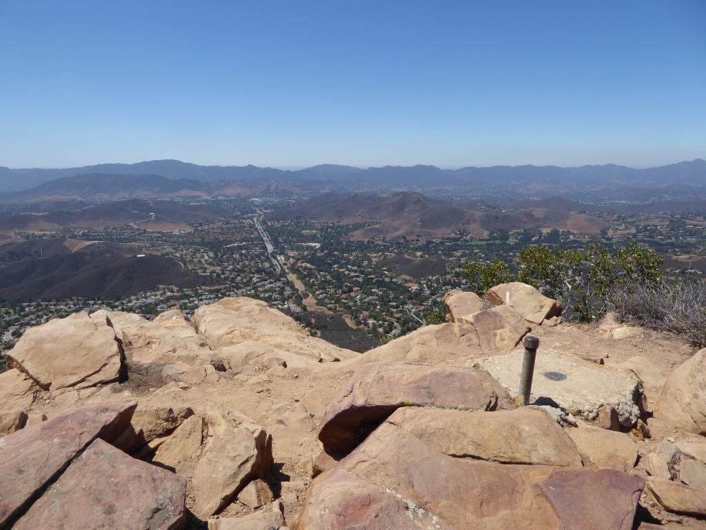 You are now at Simi Peak, the highest point of the Simi Hills. The round marker on the right is from the Ventura County Surveyor. In background is Lindero Canyon Road headed south.