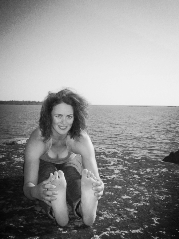 Kate in her element smiling for the camera in a seated forward fold - Paschimottanasana