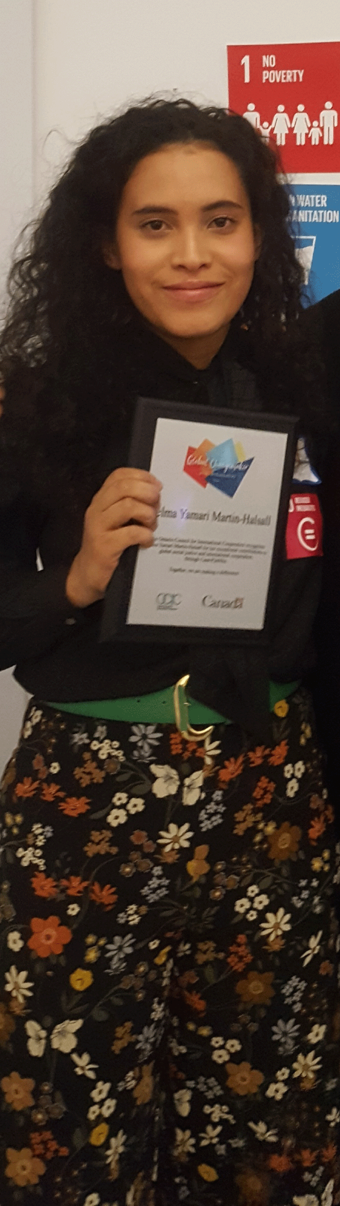 Yamari receiving her OCIC Youth Global Changemaker Award at the International Development Week event hosted by OCIC